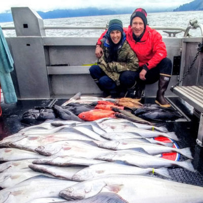 a couple with a halibut catch