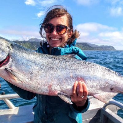 a woman holding a salmon