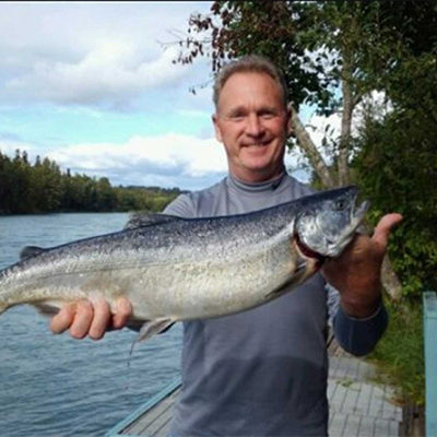 a person holding a salmon